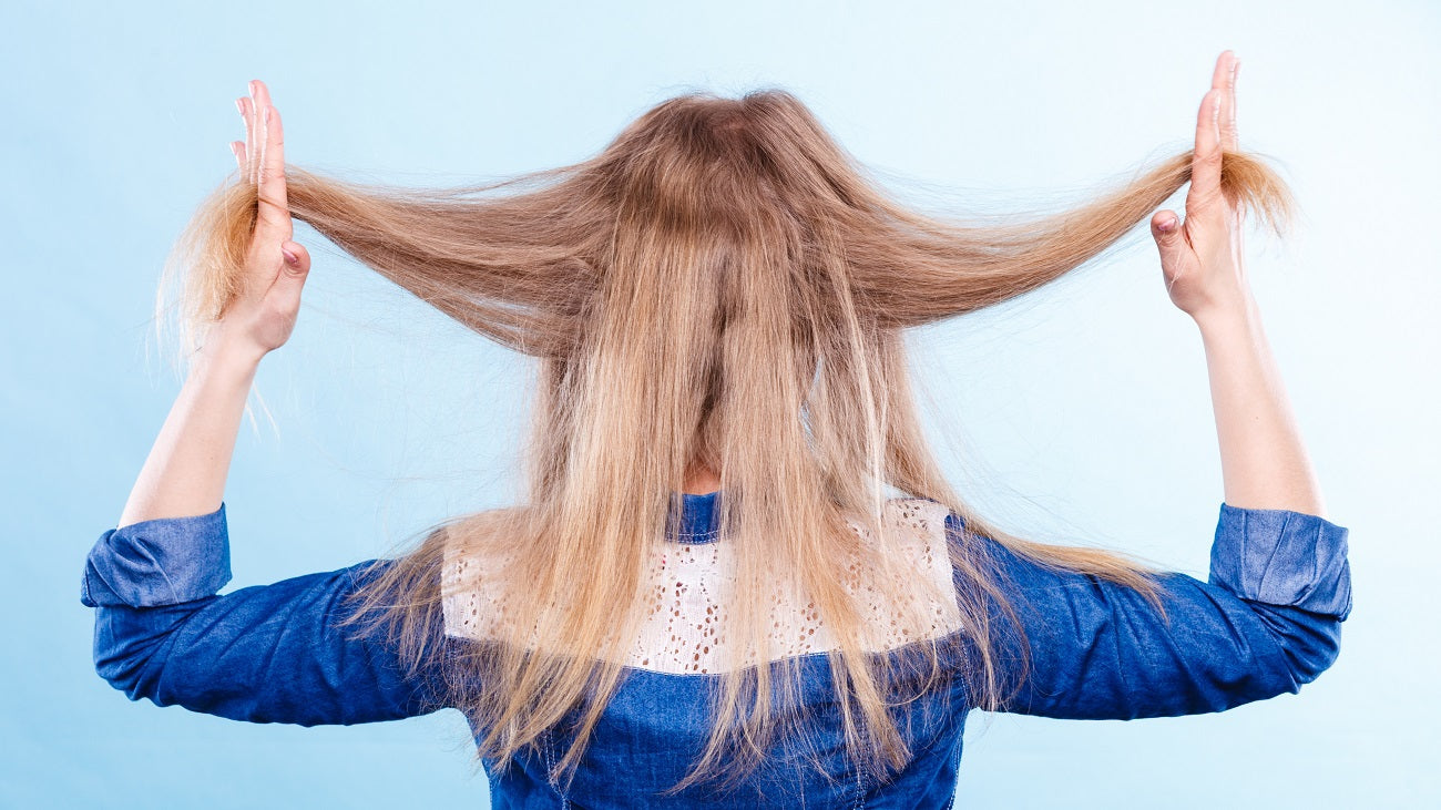 Woman dealing with frizz in her hair