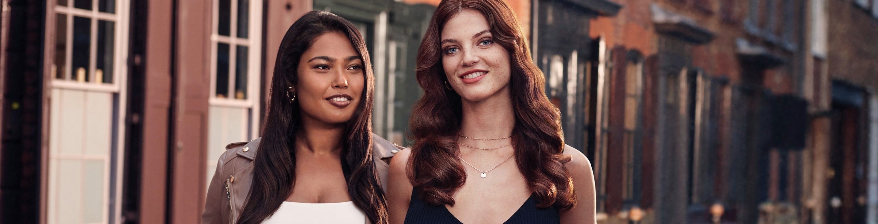 two women with sleek, frizz-free hair